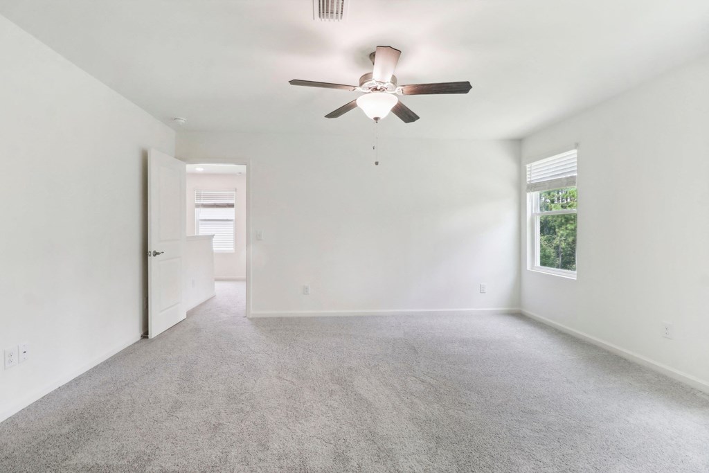 Sycamore bright bedroom with a window and carpet floor at Beacon at Ashley River Landing in Summerville, SC