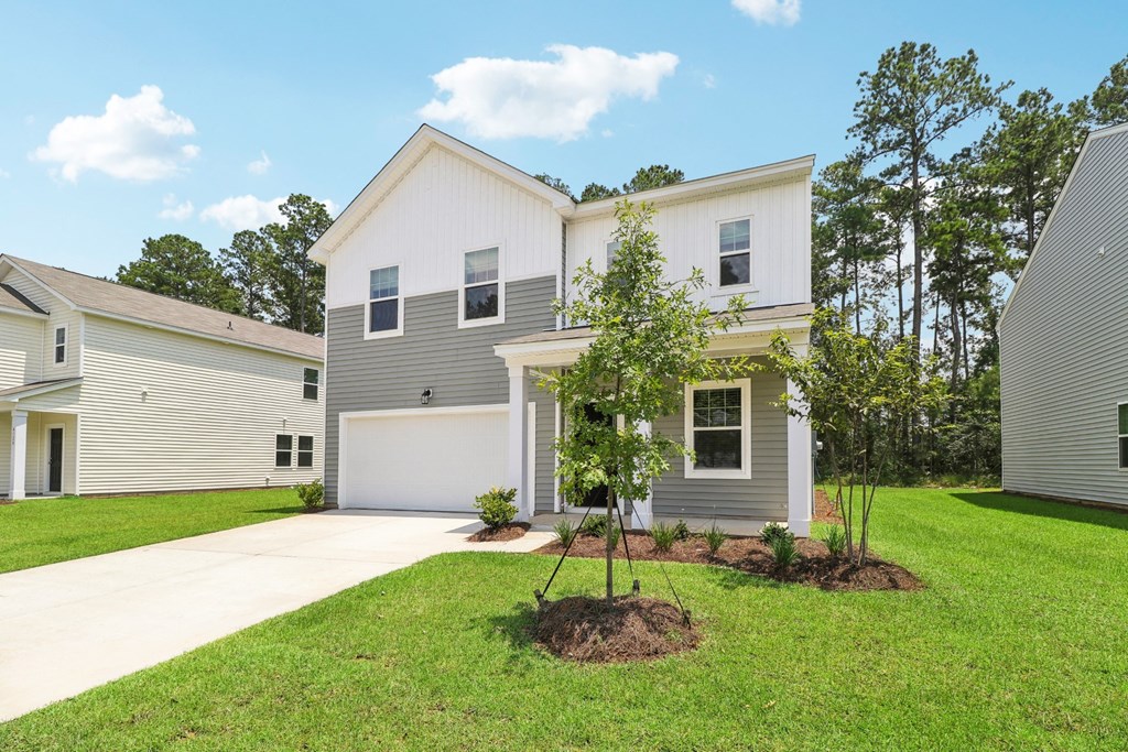 Sycamore side exterior view of a house with lawn at Beacon at Ashley River Landing in Summerville, SC
