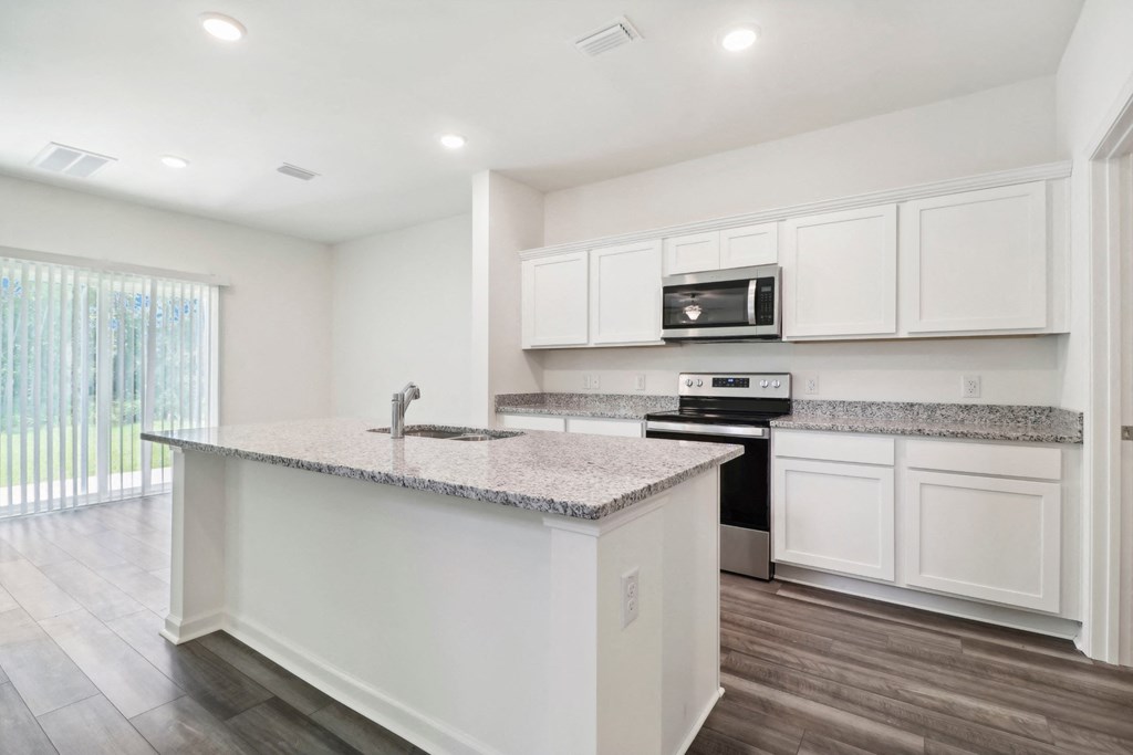 Sycamore kitchen with white cabinets and a counter top at Beacon at Ashley River Landing in Summerville, SC