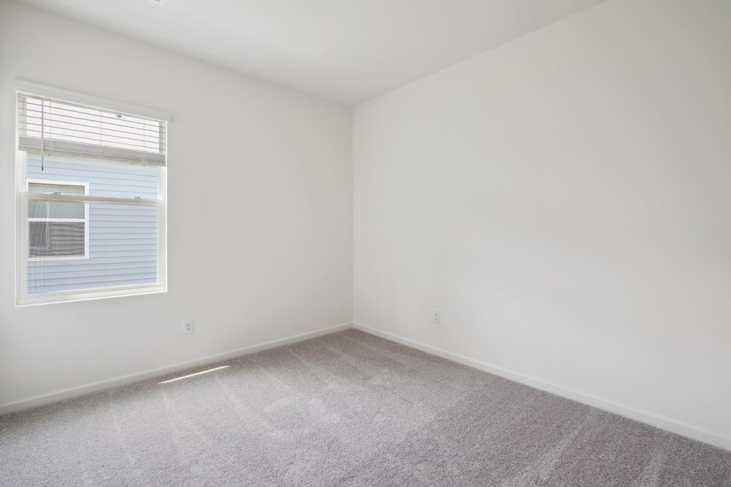 a bedroom with white walls and carpet  at Beacon at Meridian, San Antonio, TX 78245