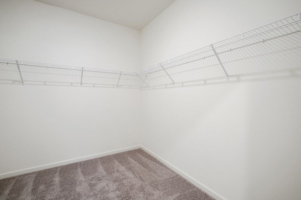 a walkin closet with white walls and white wire shelving at Beacon at Meridian, San Antonio Texas
