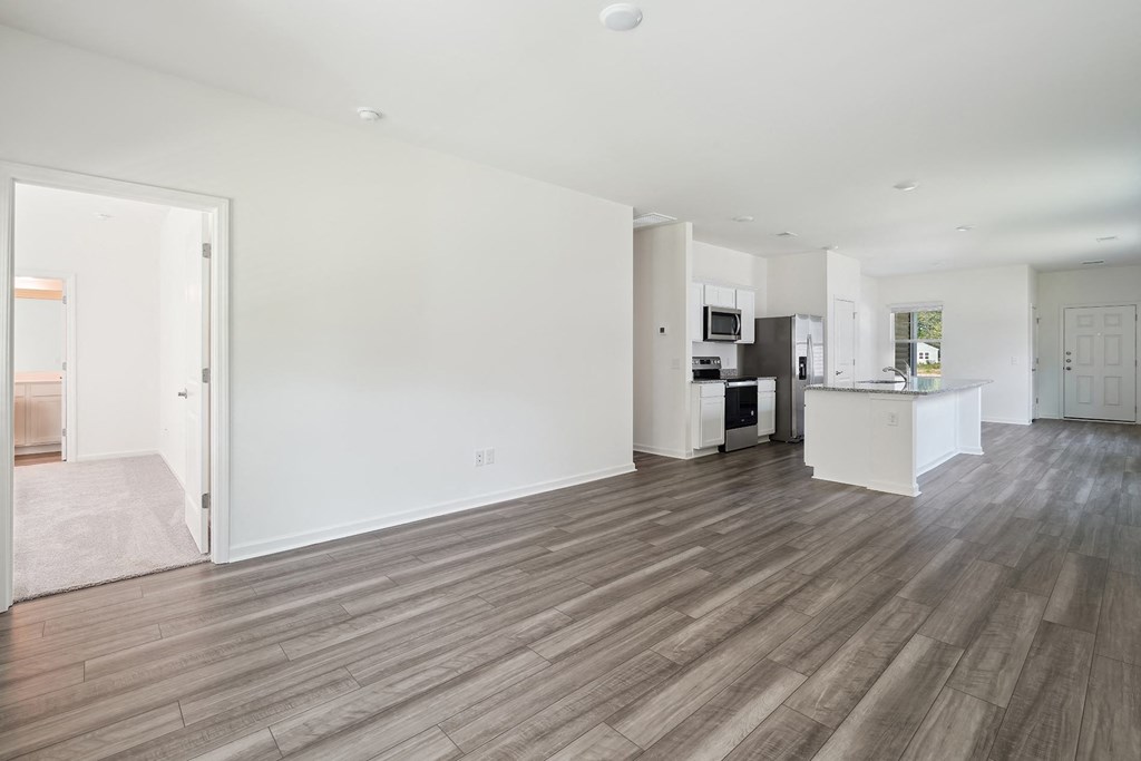 a living area with hardwood floors and white walls at Beacon at Meridian, San Antonio, TX