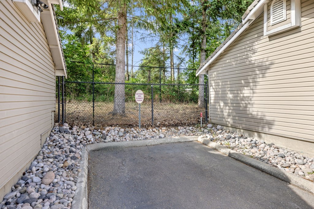 A car wash area with trees behind it at Abbey Rowe Apartments in Olympia, WA