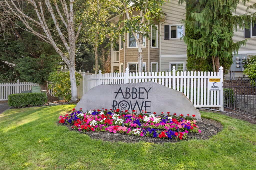 An entry sign for Abbey Rowe Apartments in Olympia, WA
