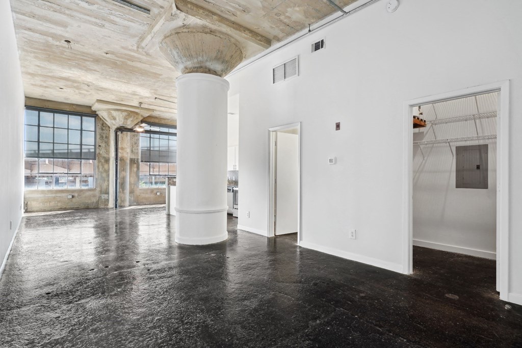 Entrance into loft apartment with white walls and large support column adding an urban touch | Adam Hats Lofts from Deep Ellum Lofts in Dallas, TX