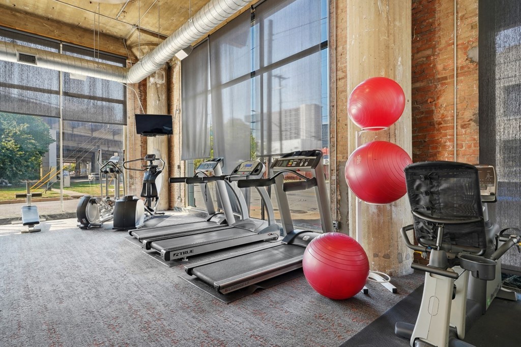 Adam Hats fitness center with treadmills and other cardio equipment | Adam Hats Lofts from Deep Ellum Lofts in Dallas, TX