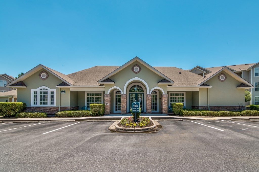 a large house with a driveway and a parking lot