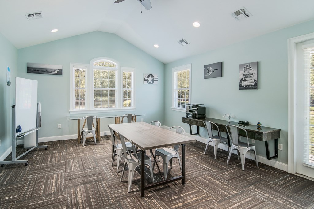 a dining room with a table and chairs and a piano
