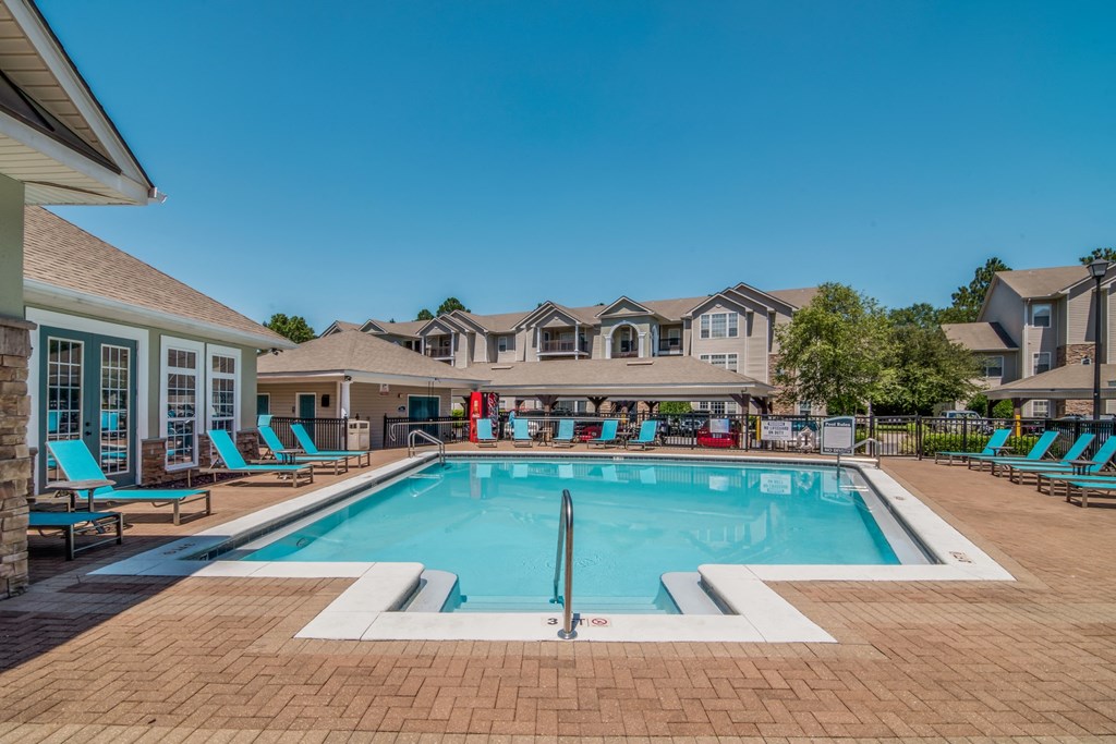 the preserve at ballantyne commons pool with lounge chairs and apartment buildings