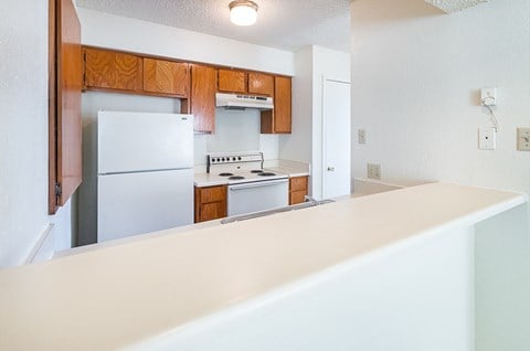 Unit Kitchen with White Appliances at Heritage Square Apartments in Waco, TX