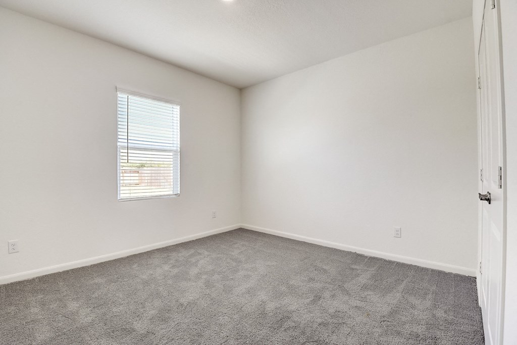 a bedroom with white walls and carpet at Beacon at Meridian, San Antonio, 78245