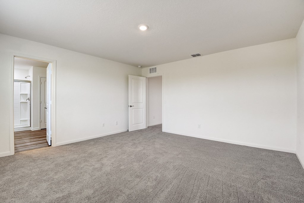a bedroom with white walls and carpet at Beacon at Meridian, San Antonio, 78245