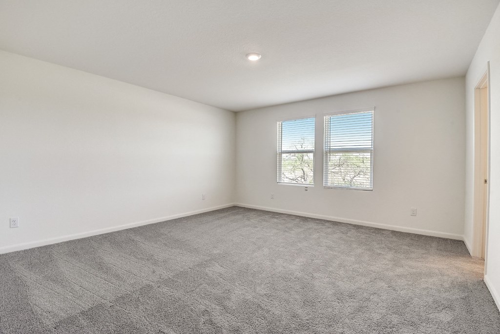 a bedroom with white walls and carpet at Beacon at Meridian, Texas, 78245
