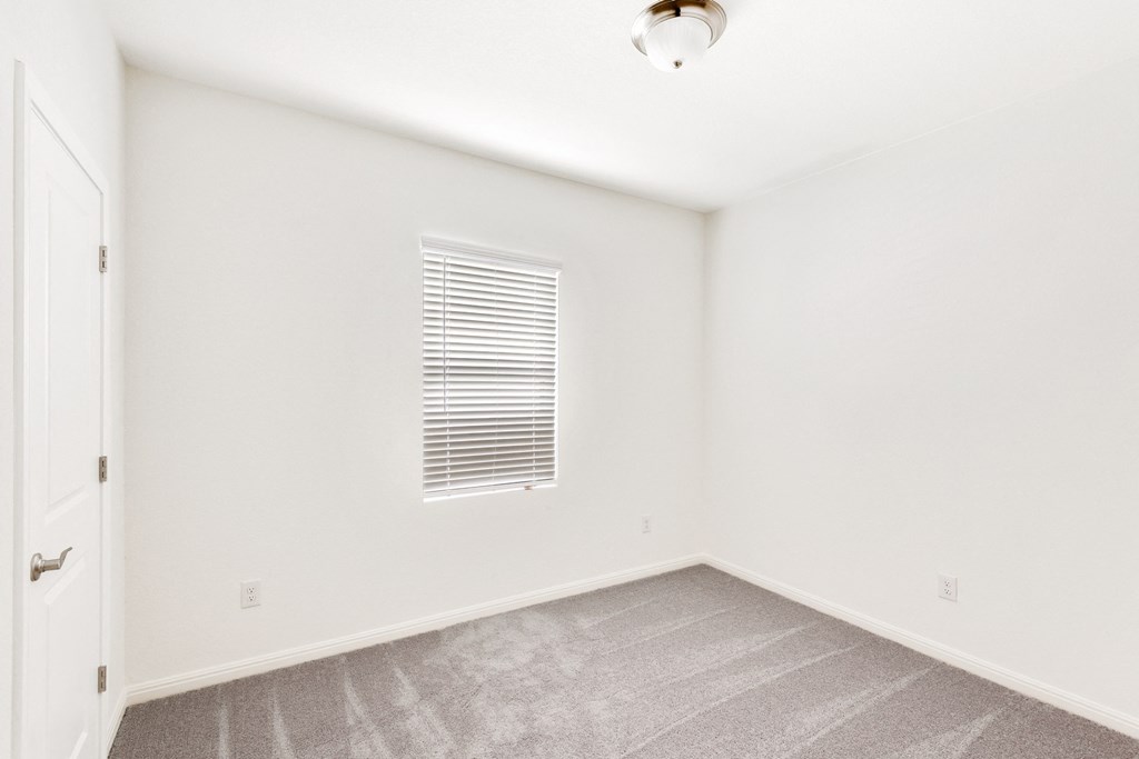 a bedroom with white walls and carpet at Beacon at Meridian, Texas