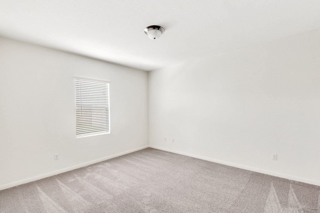 a bedroom with white walls and carpet at Beacon at Meridian, San Antonio Texas