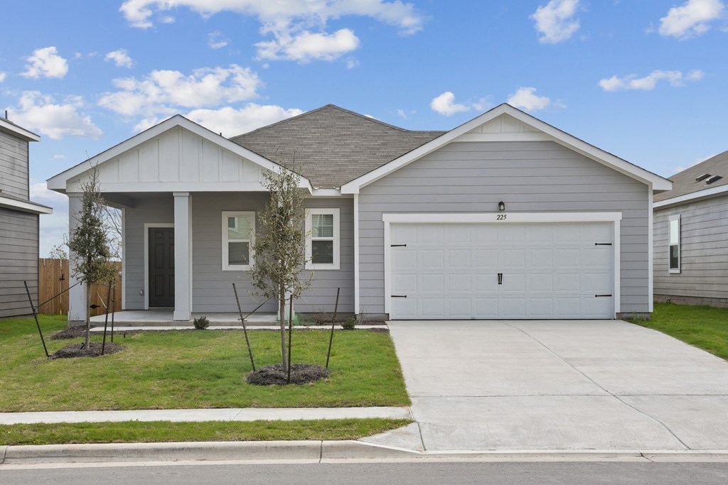 a home with a gray siding and a white garage door at Beacon at Bunton Creek, Kyle