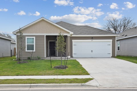 a home with a gray siding and a white garage door at Beacon at Bunton Creek, Kyle Texas