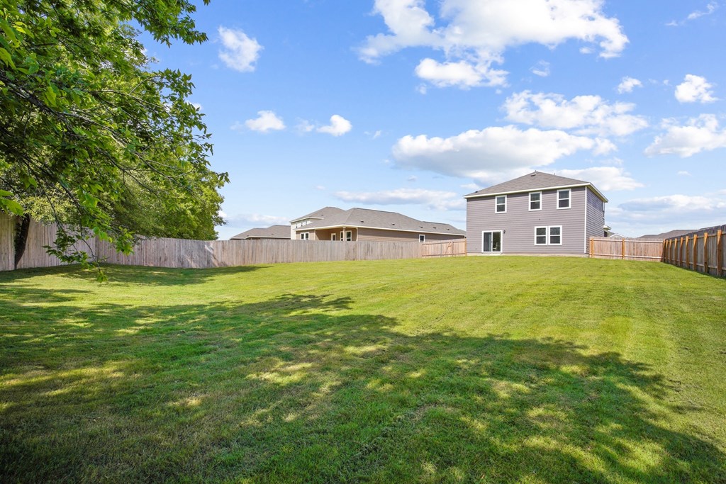 a yard with a house in the background at Beacon at Bunton Creek, Kyle, TX 78640