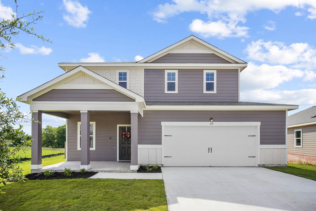 a house with gray siding and a gray garage door at Beacon at Bunton Creek, Kyle