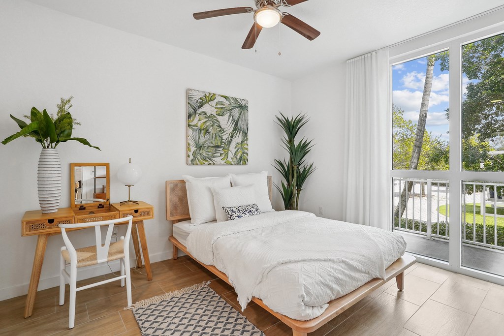 a bedroom with a bed and a desk with a chair