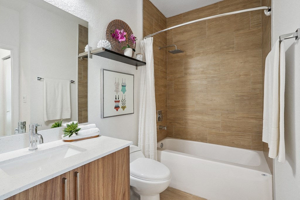 a bathroom with a white toilet next to a bathtub