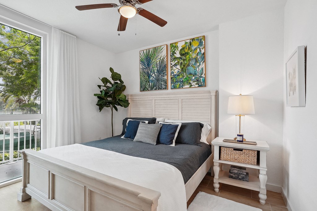 a bedroom with a bed and a ceiling fan