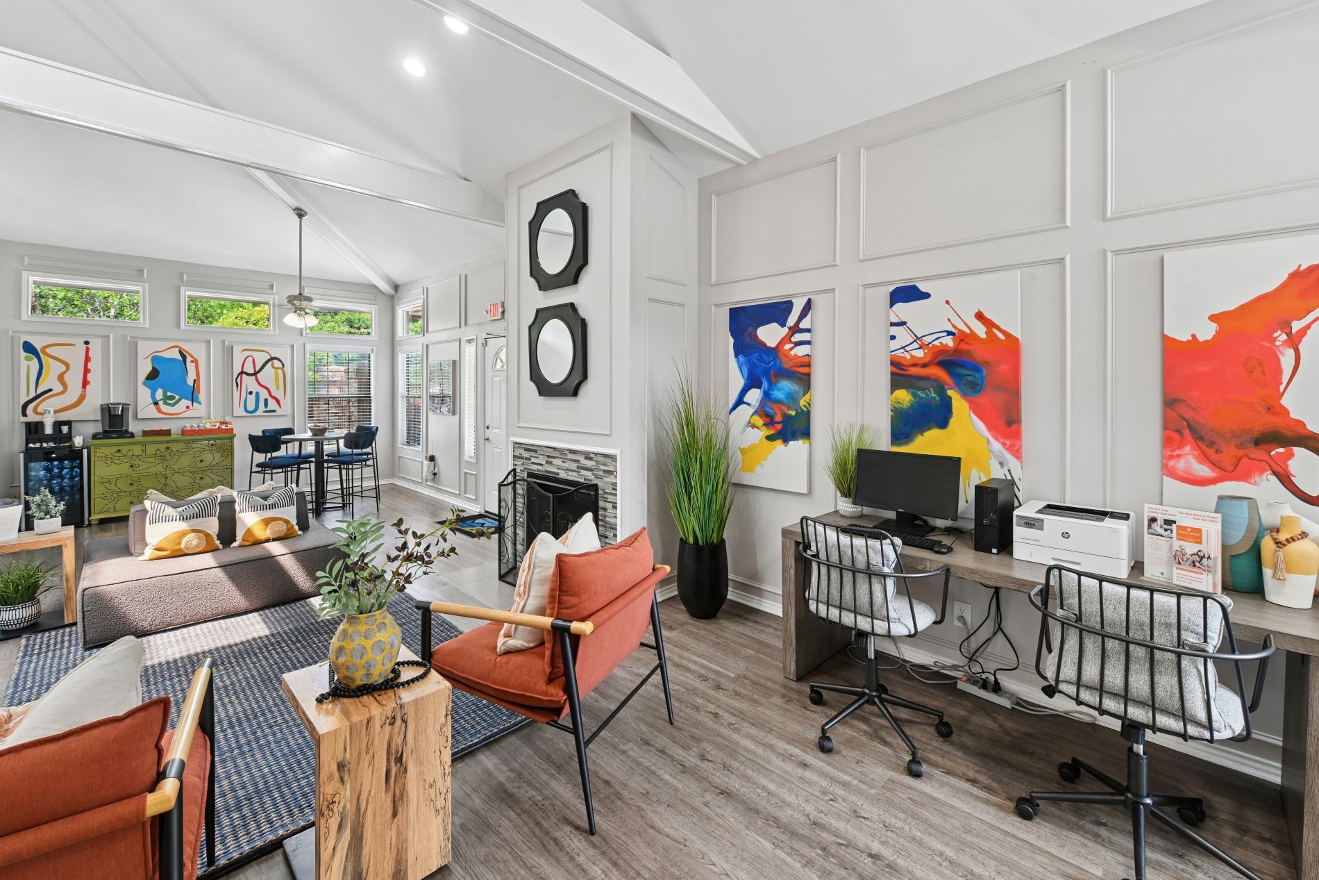 A modern living room with a fireplace and a painting on the wall.