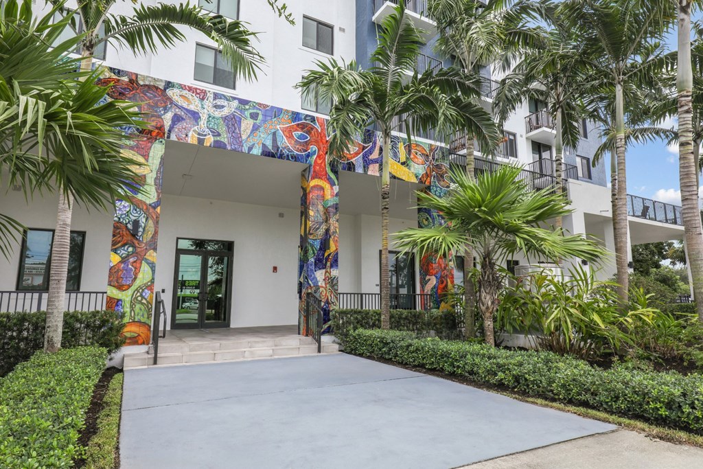 One of the entrances to our community with mural designs and palm trees at Bay Village 1 in Palmetto Bay, FL