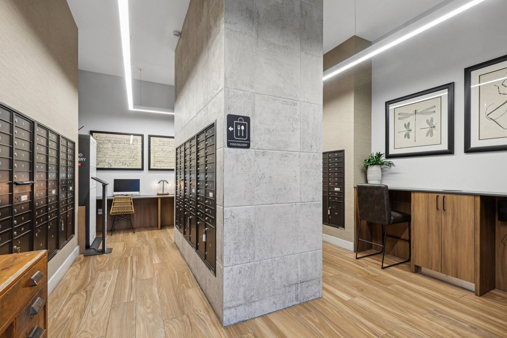 Indoor mail room close to the lobby area with computer center and food delivery pods at Bay Village 1 in Palmetto Bay, FL