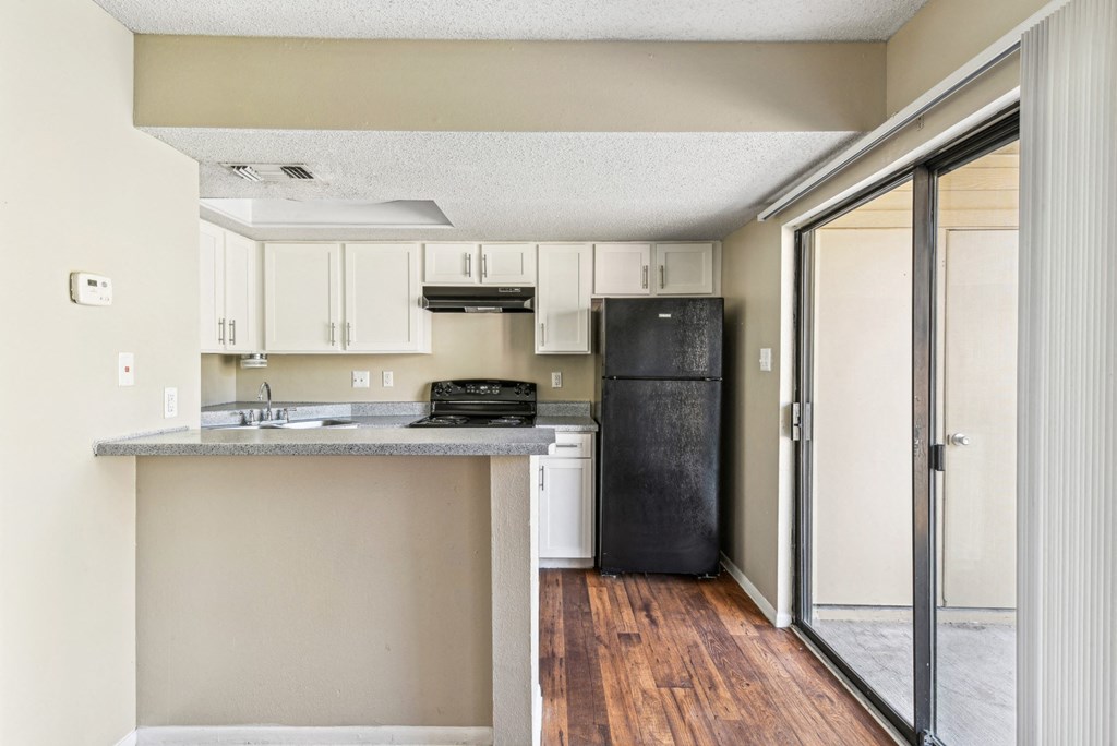 Gourmet kitchen with black appliances at Bandera Crossing apartments in San Antonio, TX