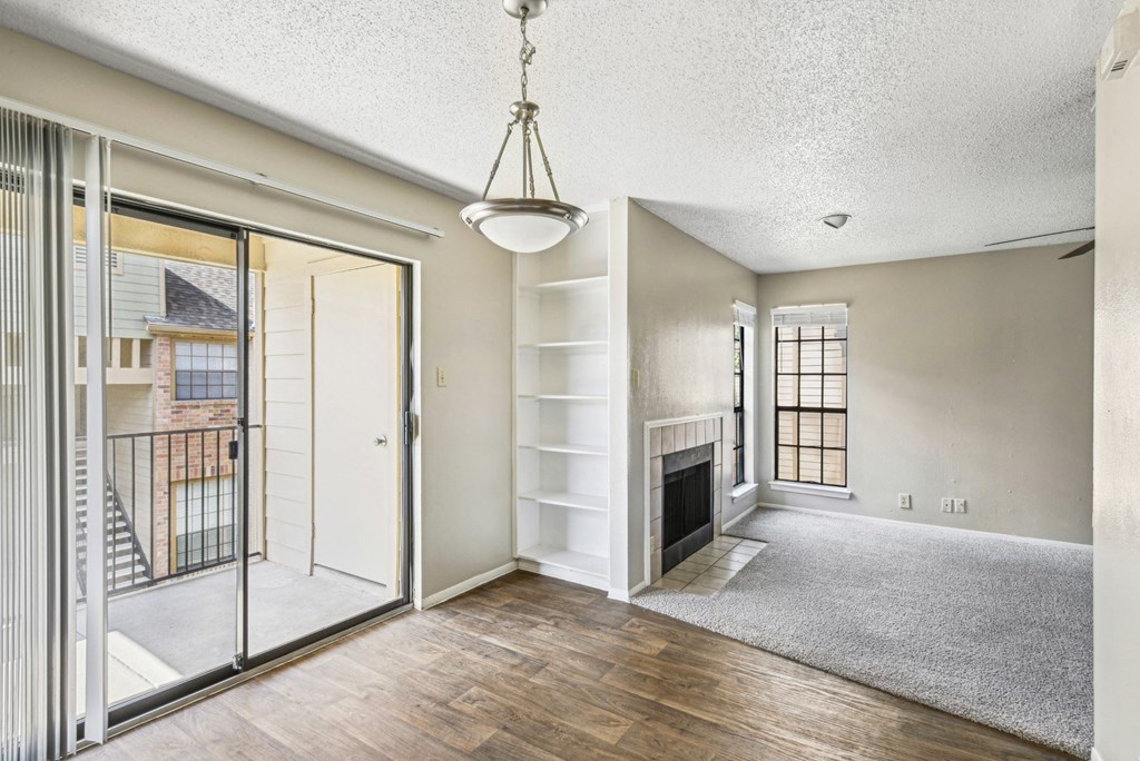 Living room connected to  a private patio with sliding glass door at Bandera Crossing apartments in San Antonio, TX