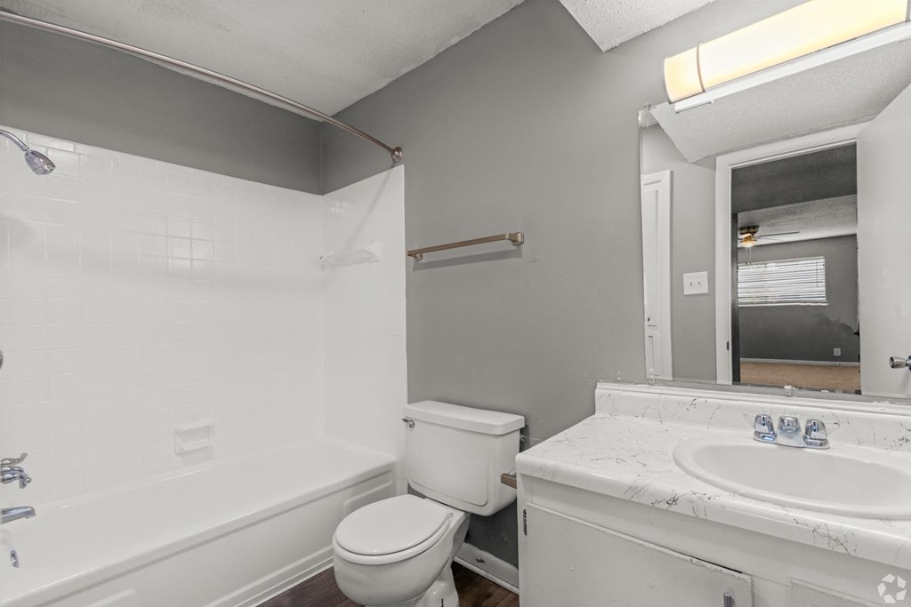 Apartment bathroom with white hardware at Bayou Oaks Apartment Homes in Alexandria, LA