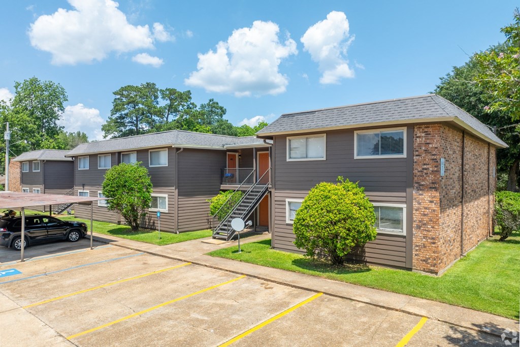Two apartment buildings with a parking lot at Bayou Oaks Apartment Homes in Alexandria, LA