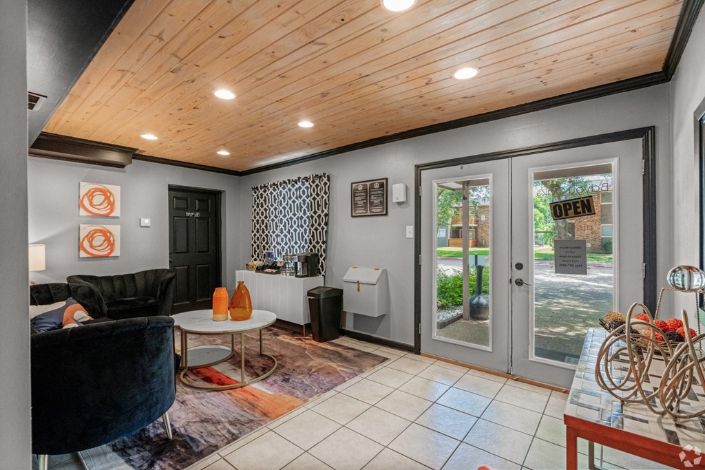 Leasing office interior with glass doorway and coffee maker at Bayou Oaks Apartment Homes in Alexandria, LA