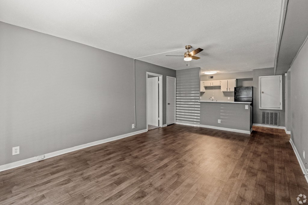 Apartment living room with a wood floors and a kitchen at Bayou Oaks Apartment Homes in Alexandria, LA