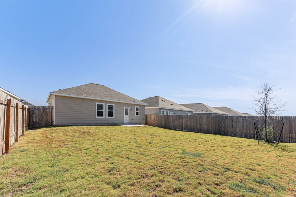 Backyard with a grassy area for outdoor activities of Dogwood floor plan at Beacon at Presidential Heights in Manor, TX