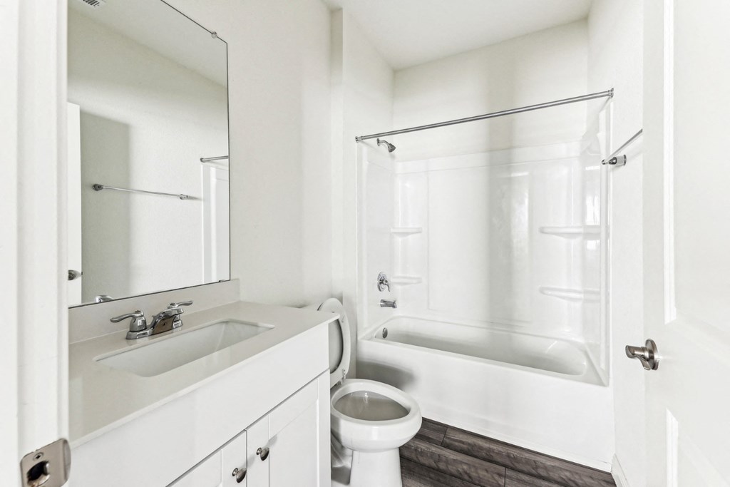 Spacious bathroom in Dogwood home with a bathtub and tile flooring at Beacon at Presidential Heights in Manor, TX