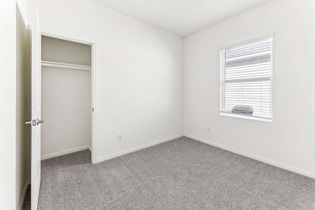 Bedroom with a large closet for ample storage of Dogwood floor plan at Beacon at Presidential Heights in Manor, TX