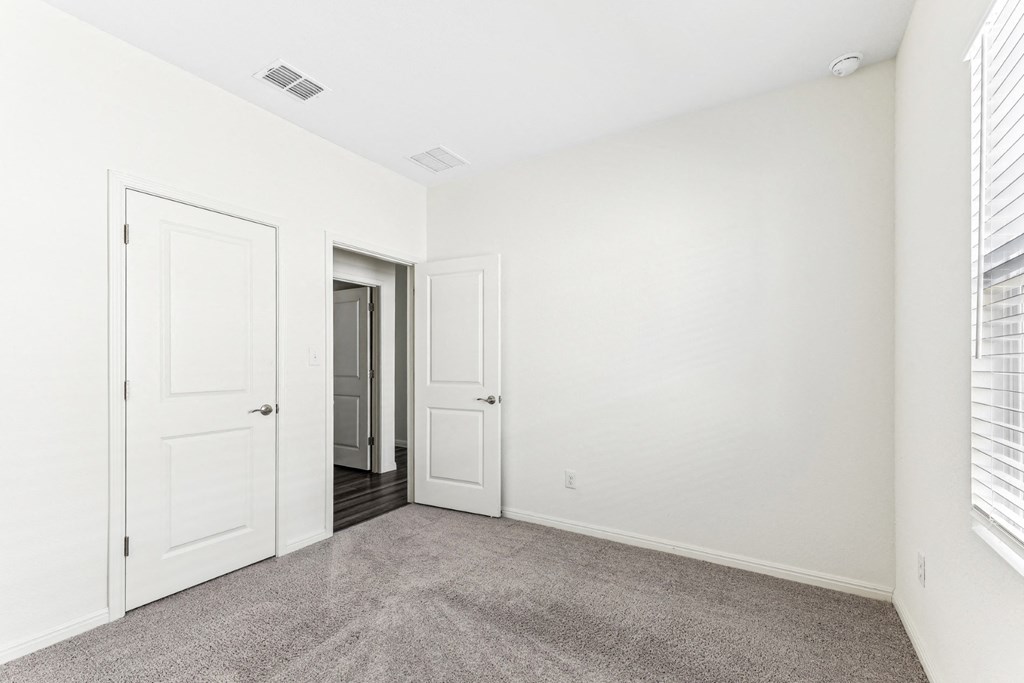 Bedroom with white walls of Dogwood floor plan at Beacon at Presidential Heights in Manor, TX