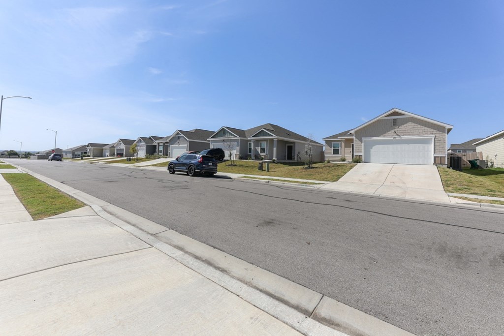 Side view of the driveway looking toward the Dogwood home floor plan type at Beacon at Presidential Heights in Manor, TX