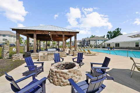 Firepit with blue chairs at Capital Grand Apartments in Tallahassee, FL