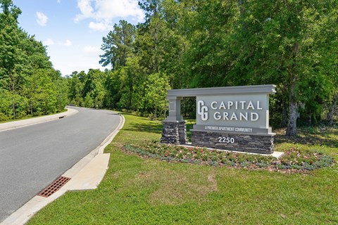 Capital Grand sign on the side of a road at Capital Grand Apartments in Tallahassee, FL