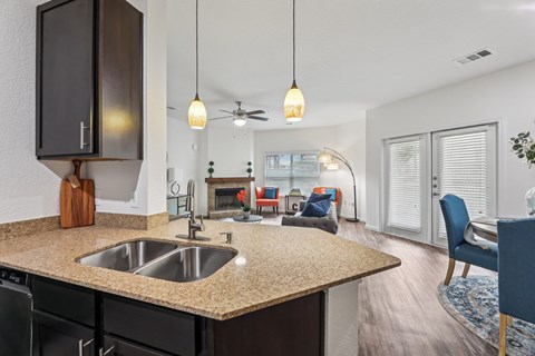 B3 kitchen that connects to the living room at Creekside on Parmer Lane Apartments in Austin, TX