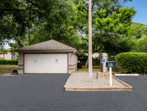 A car wash station is located in front of a garage.