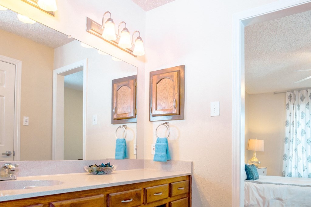 Bathroom with large vanity and drawers at Chisholm Place Apartments in Plano, TX