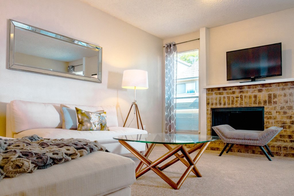 Model living room low shot from couch at Chisholm Place Apartments in Plano, TX