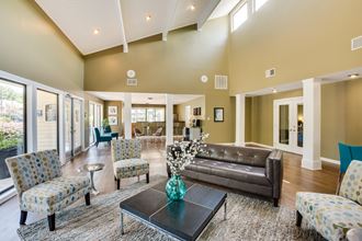 a living room filled with furniture and a large window