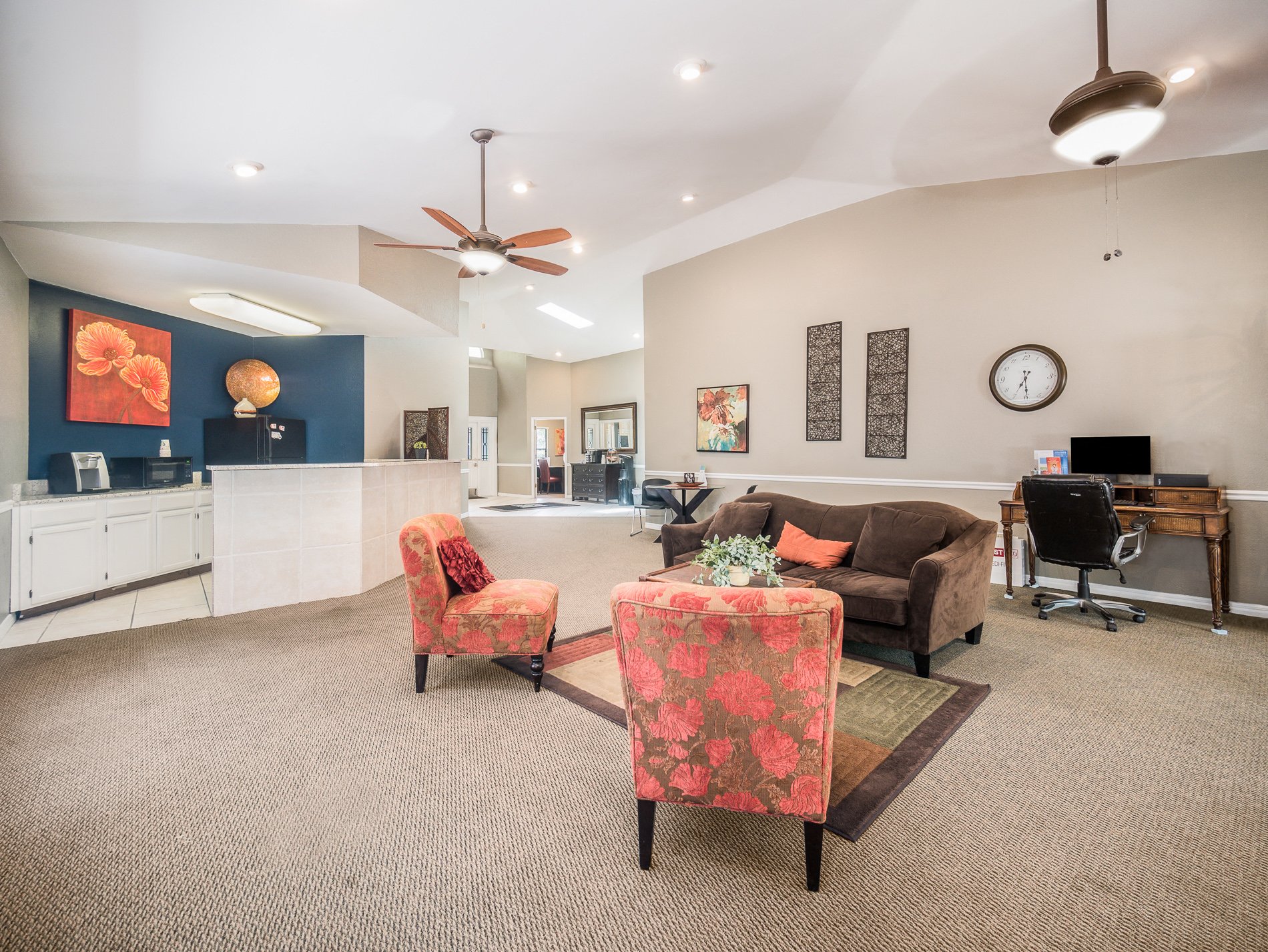 a living room with a couch and chairs and a table