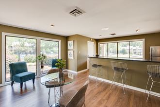 a kitchen and living room with a bar