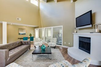a living room with a fireplace and a flat screen tv